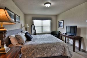 a bedroom with a large bed and a television at Unit 311 1 Bd 1 Ba Condo Condo in Birchwood