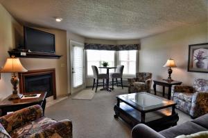 a living room with a couch and a table at Unit 311 1 Bd 1 Ba Condo Condo in Birchwood