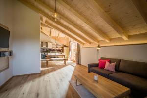 a living room with a couch and a table at Lainthalerhof in Oberaudorf