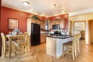 a kitchen with a black refrigerator and a table with chairs at Chiefs Head Peak 21B Condo in Estes Park