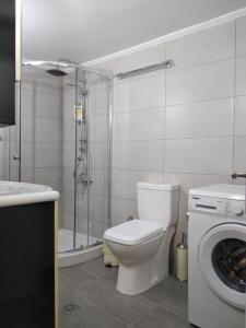 a bathroom with a toilet and a shower and a washing machine at Eleni Apartments in Preveza +39 photos