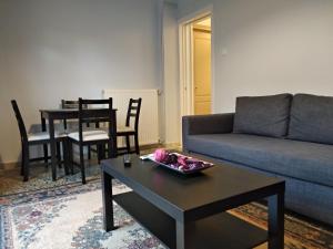 a living room with a couch and a table at Eleni Apartments in Preveza