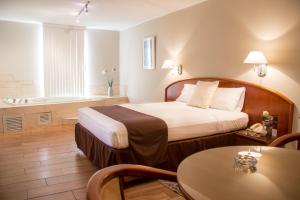 Ένα ή περισσότερα κρεβάτια σε δωμάτιο στο Hotel Park Suites
