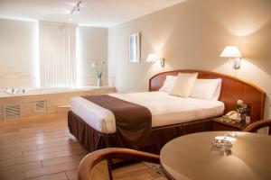 Postel nebo postele na pokoji v ubytování Hotel Park Suites