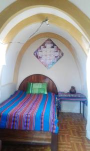 מיטה או מיטות בחדר ב-Hostal Qhana Pacha