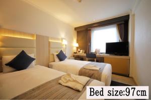 Postel nebo postele na pokoji v ubytování Hotel Sunroute Stellar Ueno