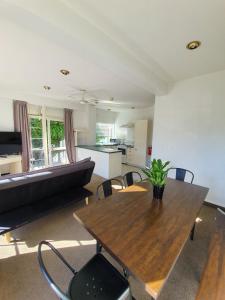 a living room with a table and a couch at U Studios Paraparaumu Beach in Paraparaumu Beach
