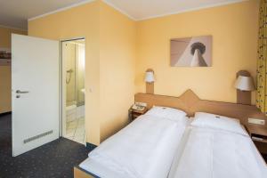 Postel nebo postele na pokoji v ubytování Central Hotel