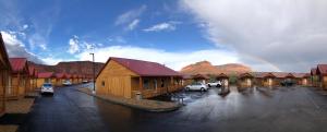 a group of buildings with cars parked in a parking lot at Red Canyon Cabins in Kanab