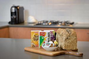 a cutting board with a loaf of bread and a can of food at Ringwood Royale in Ringwood
