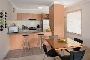 a kitchen with a table and a dining room at Ringwood Royale in Ringwood