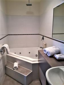 a bathroom with a tub, sink, and toilet at Pittsworth Motor Inn in Pittsworth