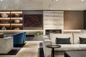 a living room with a couch and a fireplace at Quay West Suites Melbourne in Melbourne