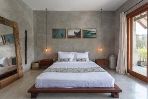 A bed or beds in a room at Kano Canggu