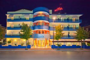 a hotel building with a hotel sign in front of it at Hotel Catto Suisse in Caorle