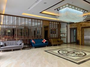 a lobby with two couches and a chandelier at Emma Hotel in Ha Long