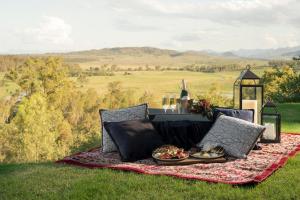 a picnic blanket with food on it on a field at Spicers Hidden Vale in Grandchester