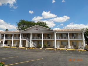 an empty parking lot in front of a hotel at Colony Motel in Brookfield