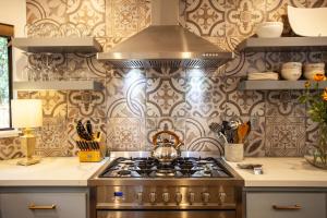 a kitchen with a stove with a tea kettle on it at 758 Broadway House in Sonoma