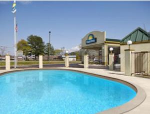 a large blue pool in front of a hotel at Days Inn by Wyndham Eufaula AL in Eufaula
