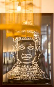 a sculpture of a head in a glass window at Purple Hue Central Hub in Hue