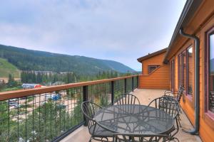 a balcony with a table and chairs and a view at 8912 The Springs Condo in Keystone