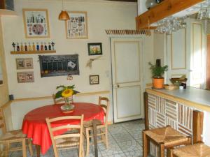 a kitchen and dining room with a table and chairs at Chambres d'Hôtes La Turone in Cheillé