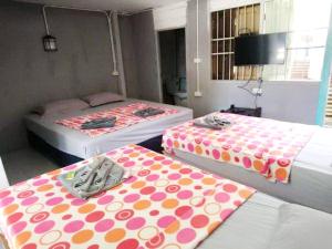 a room with two beds with polka dot sheets at Tuk Tuk Guesthouse in Ko Chang