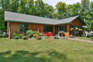 a small house with a lawn in front of it at Namakagon Landing Condo in Cable