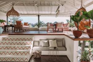 a living room with a couch on a porch at La Payesa in Canggu
