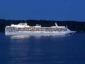 a cruise ship on the water at night at Above Tide Motel in Campbell River