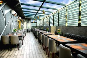 a row of tables and chairs in a restaurant at Hotel Landmark Near Golden Temple in Amritsar