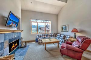 a living room with a couch and a fireplace at L306 Kirkwood Lodge in Kirkwood