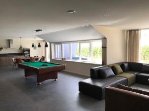 a living room with a pool table in it at Hoeve Oude Tol in Zuidzande