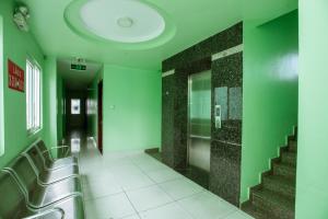 a bathroom with green walls and escalators in a building at Eden Hotel Sài gòn in Ho Chi Minh City