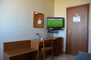 A television and/or entertainment centre at Hotel A-14
