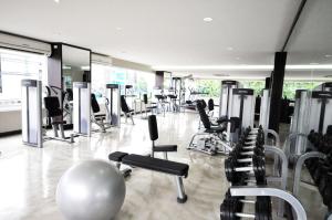 a gym with a lot of chairs and mirrors at Parinda Hotel - near Benjakitti Park & Queen Sirikit National Convention Center in Bangkok