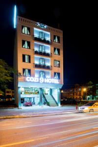 a building with a sign on the side of it at Cozi 9 Hotel in Hai Phong