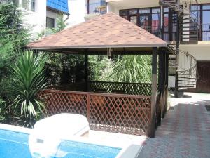 a gazebo sitting next to a swimming pool at Comfort in Alushta