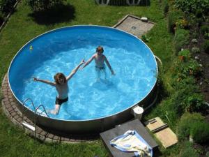 two people are in a swimming pool at Ferienhaus Rosi in Sankt Martin am Tennengebirge