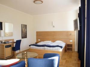 a bedroom with a bed and a table and chairs at Hindåsgården Hotel & Spa in Hindås +56 photos