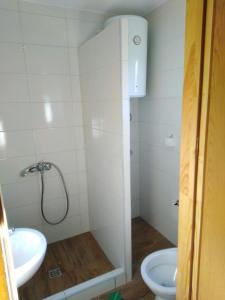 a bathroom with a shower and a toilet and a sink at Una SI in Lohovo
