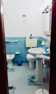 a bathroom with a sink and a toilet and a sink at Casa Vacanza Di Maggio in Cinisi