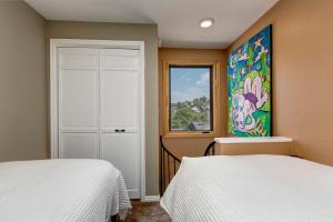 a bedroom with two beds and a window at Quitting Time Condo in Park City