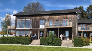 a building with people sitting outside of it at Bodelssons by the Sea in Tosteberga