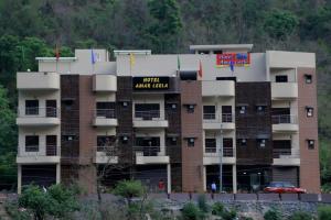 a large apartment building with a sign on it at Hotel Amar Leela in Dehradun