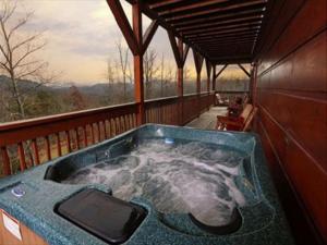 a jacuzzi tub on a porch of a house at Spacious Party Hut Near Attractions in McCookville