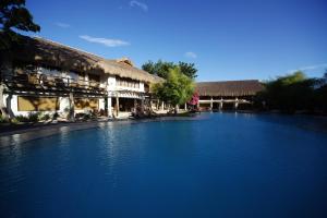 a large pool of water in front of a building at Bluewater Maribago Beach Resort in Mactan