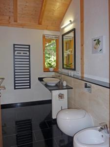 a bathroom with two sinks and a toilet at Harzer Feriengarten 5***** in Bad Suderode