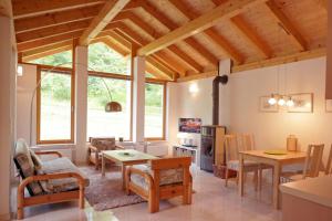 a large living room with a table and chairs at Harzer Feriengarten 4 Sterne in Bad Suderode